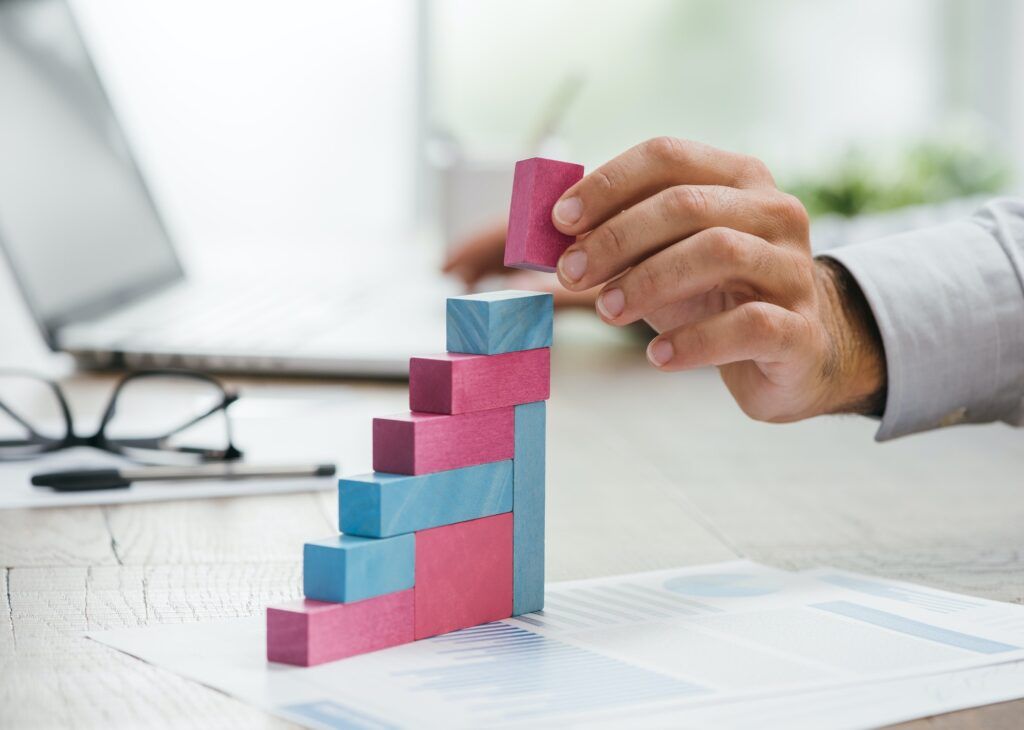 Businessman building a growing financial graph